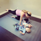 Mom in a bird dog beside her babies and cat on a large Silverback Gray exercise mat
