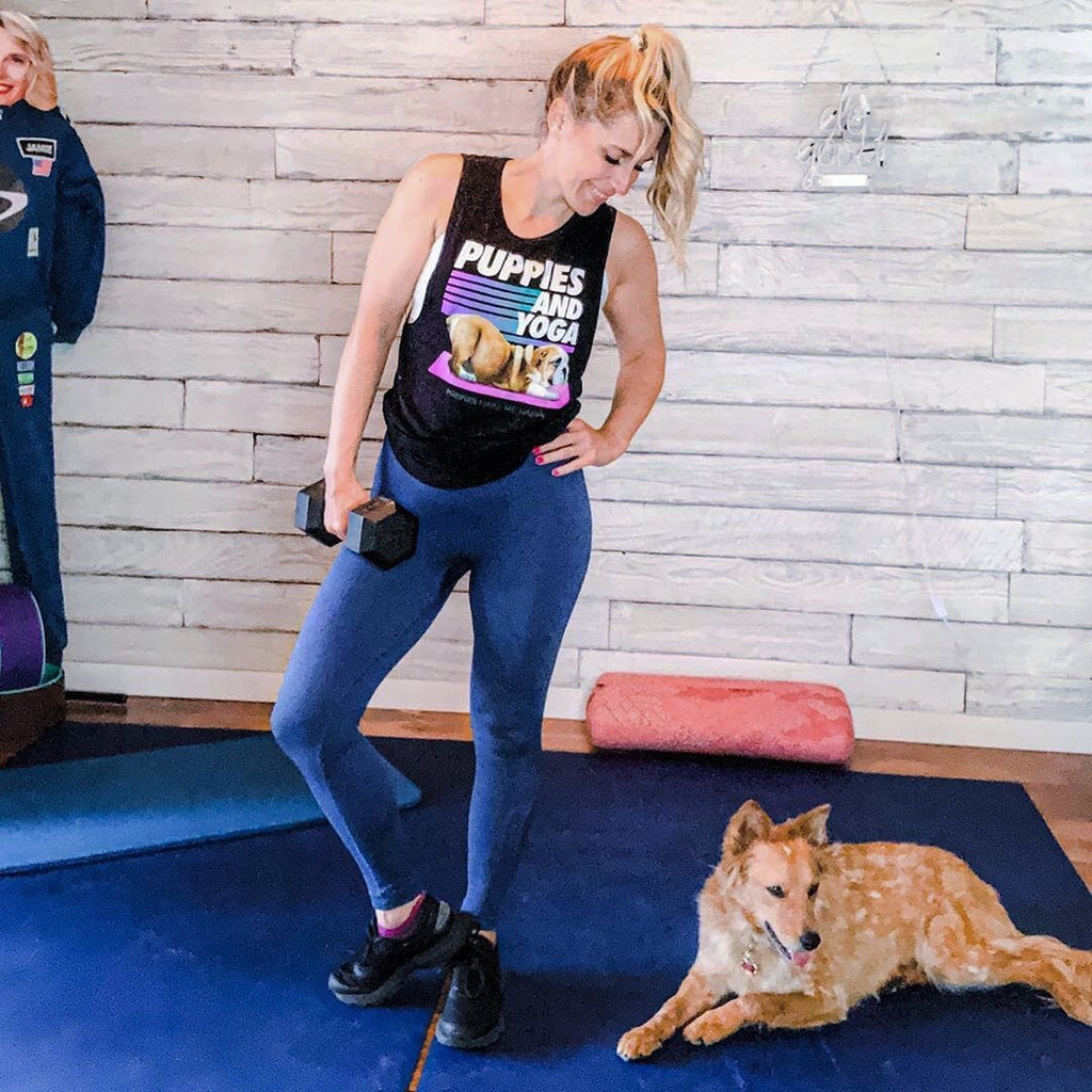 Woman holding dumbbells beside her dog on a large Midnight Blue exercise mat