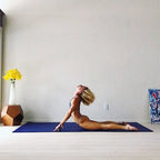 Woman in an upward stretch on a large Midnight Blue exercise mat