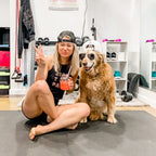 Woman sitting with her golden retriever on a large Silverback Gray exercise mat