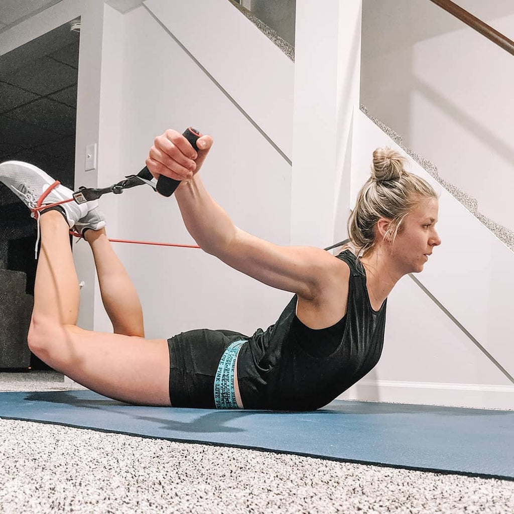 Woman in a banded bow stretch on a large Silverback Gray exercise mat