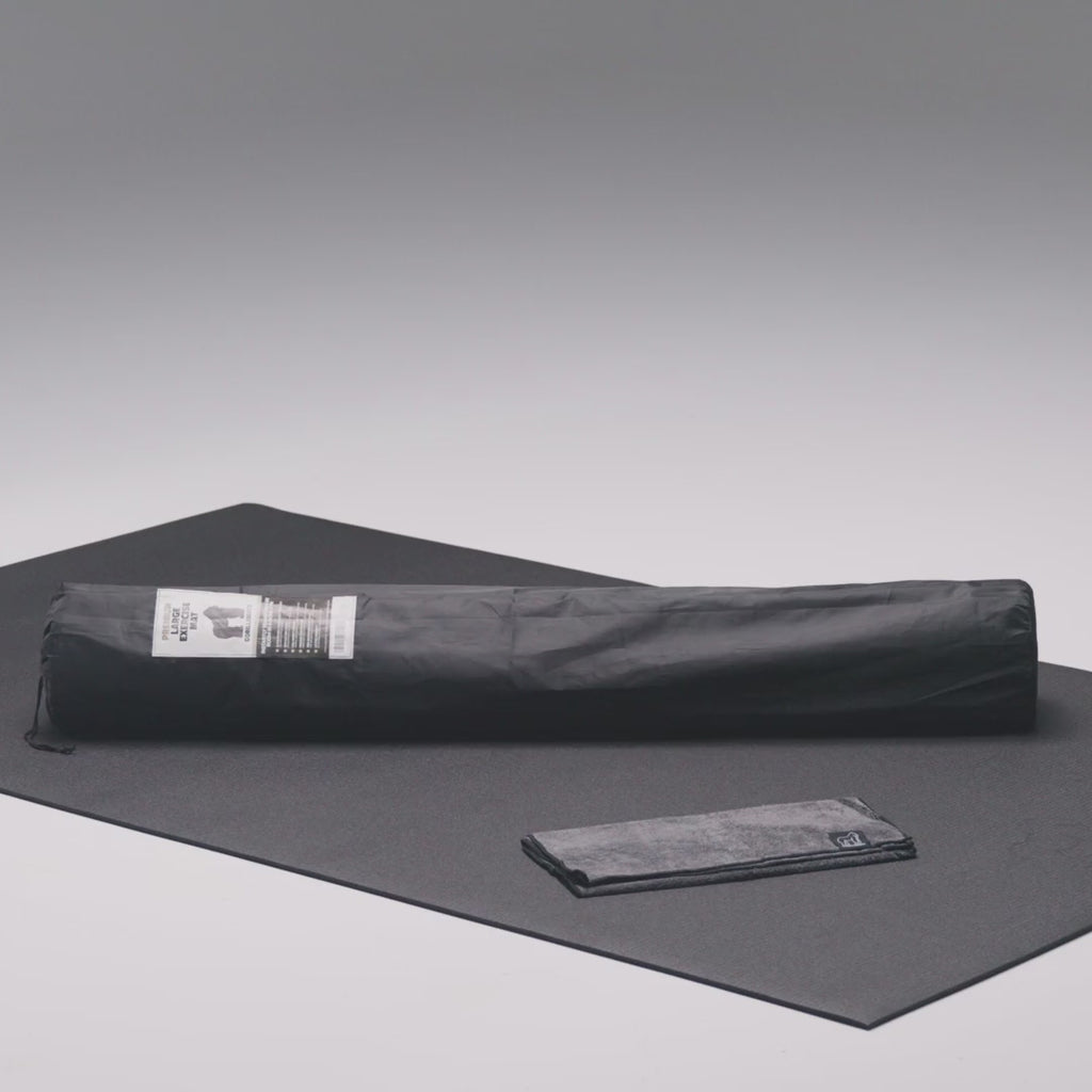 Large exercise mat in use with shoes and kettlebells