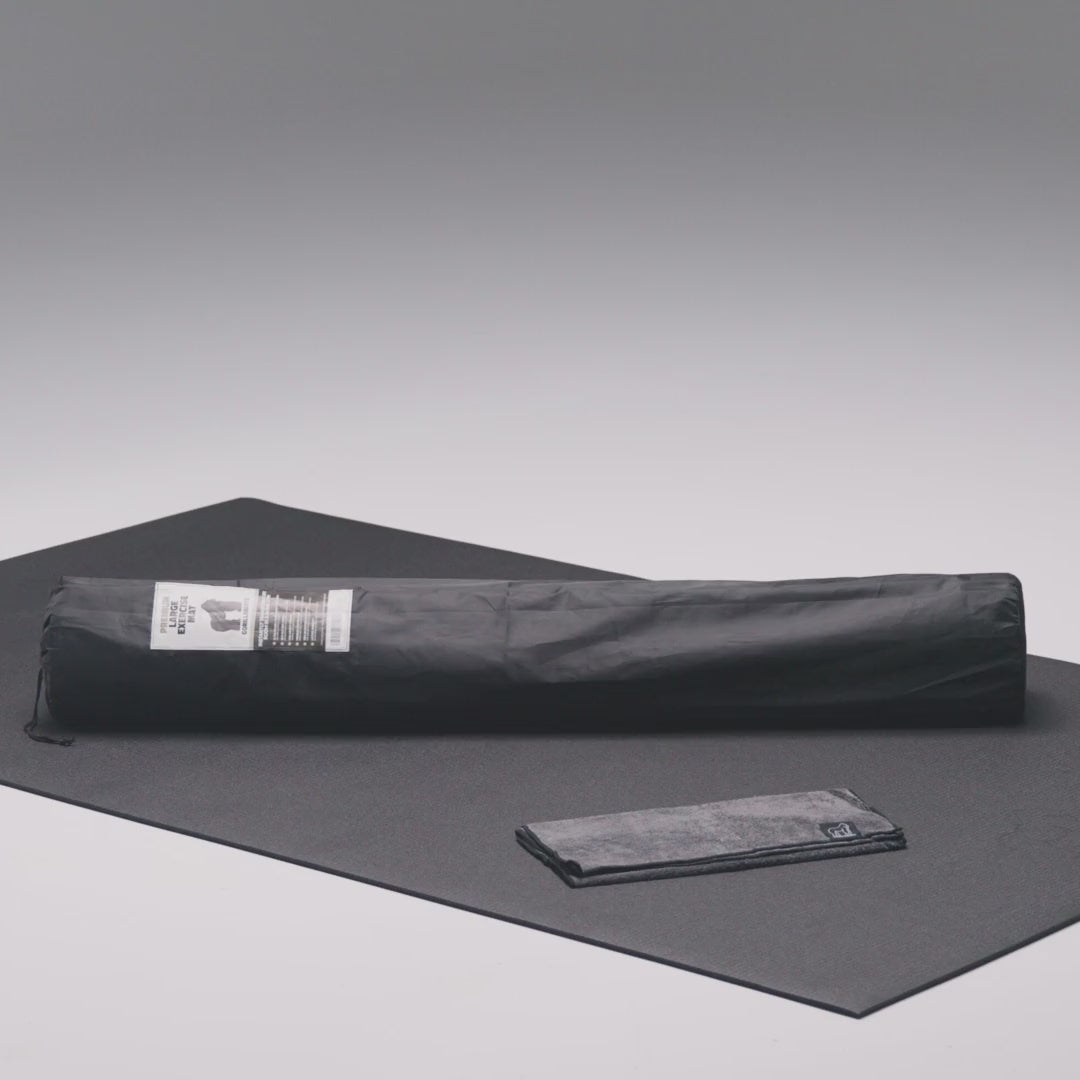 Large exercise mat in use with shoes and kettlebells