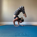 Woman in a scorpion arm balance on a large Oasis Blue yoga mat
