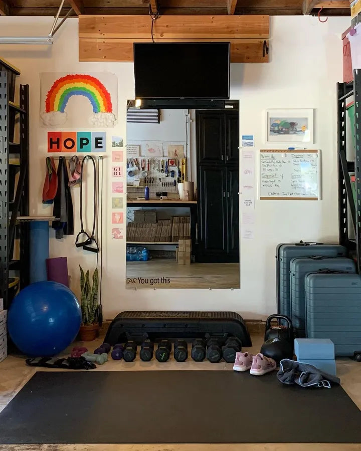 Home gym wall with a rainbow sign and a large mat across the floor